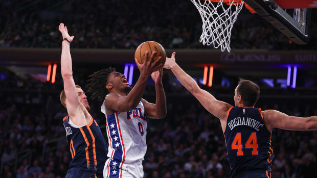 Knicks defenders Donte DiVincenzeo and Bogdan Bogdanovic converge on Tyrese Maxey